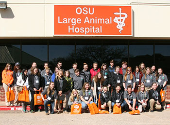 Arkansas 4-H youth on Vet Science field trip in front of Oklahoma State University's large animal  hospital.